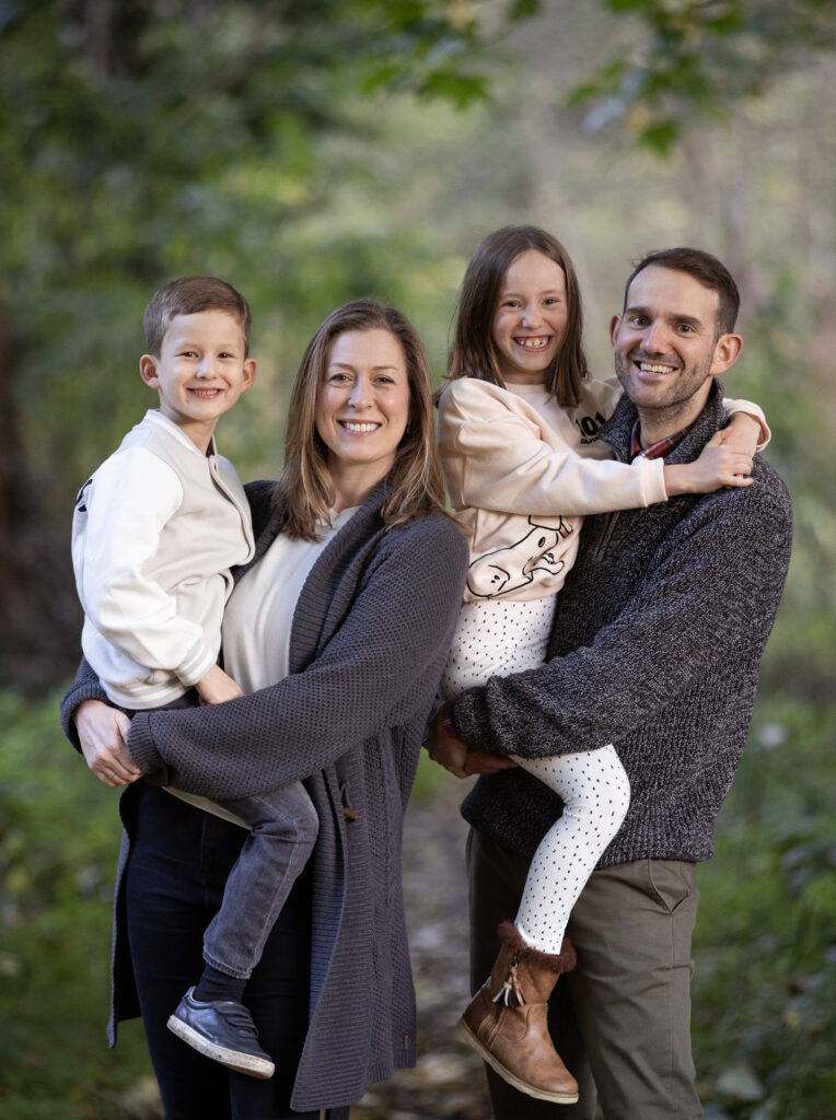 Family portrait of Rachel with her husband and two children.